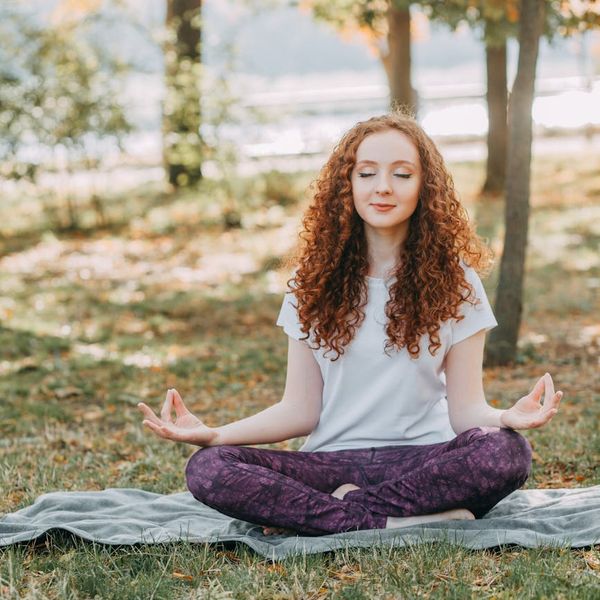Person meditating in a serene setting, representing mental clarity and peace.
