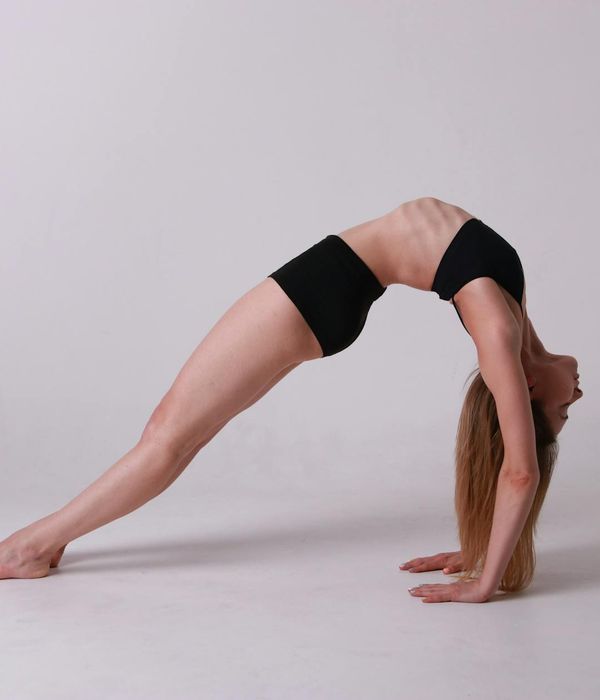 Woman in a calm yoga pose, embodying flexibility and balance.